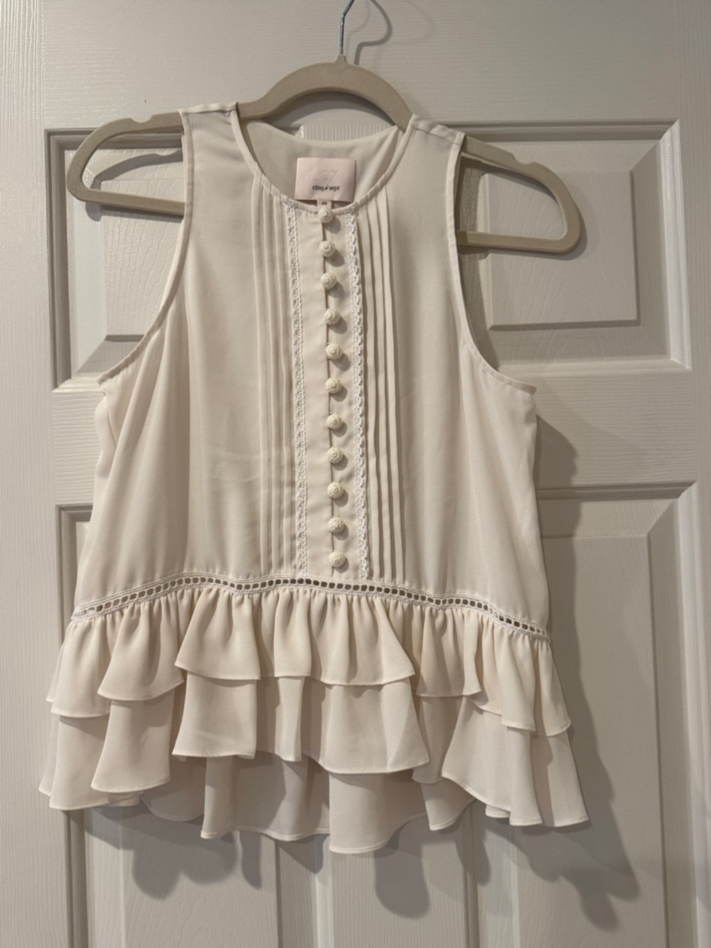 cinq à sept Cream Sleeveless Blouse with Crochet Buttons and Pintuck Front